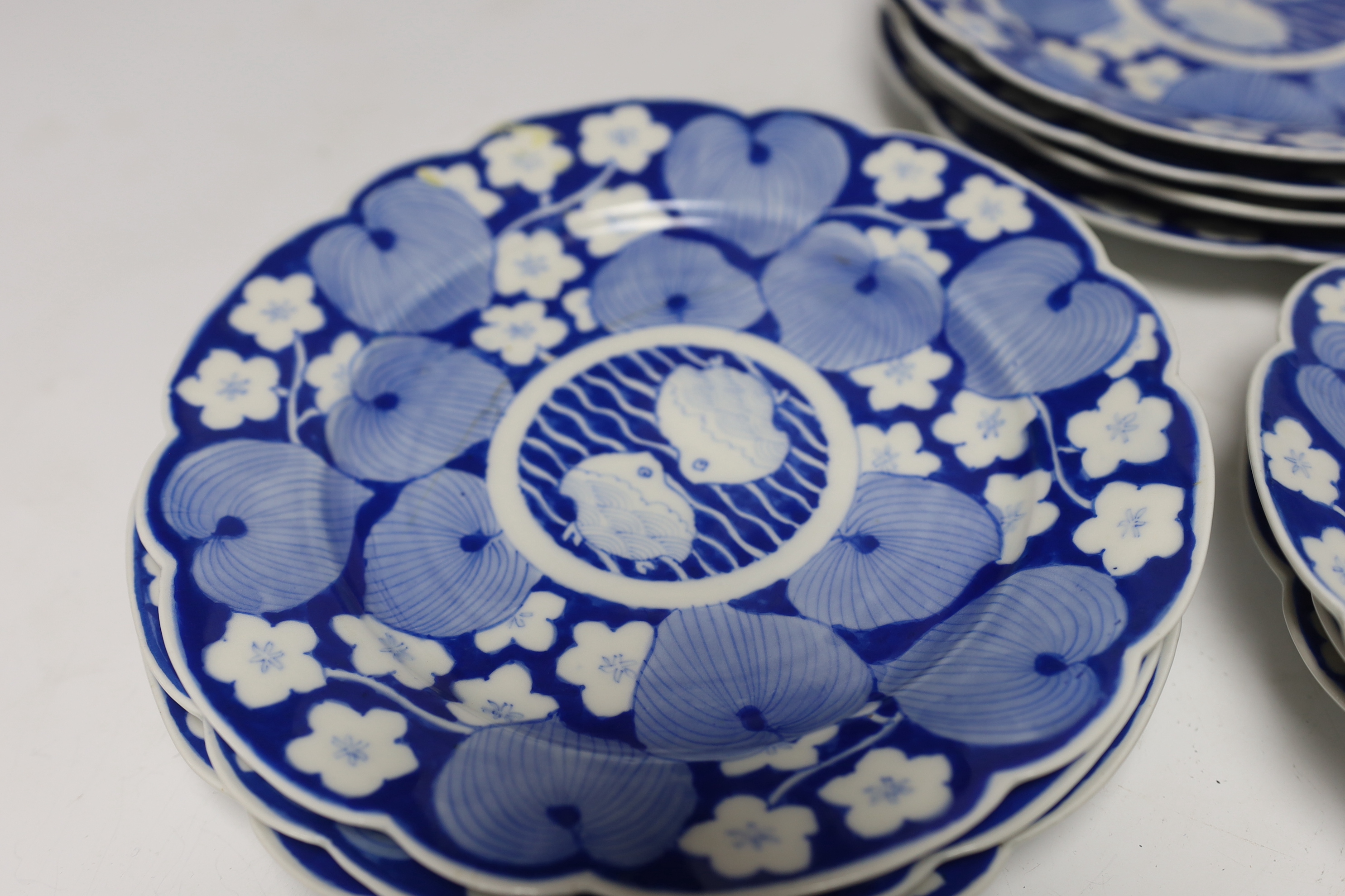Twelve Japanese blue and white ‘fish’ plates, 21cm diameter